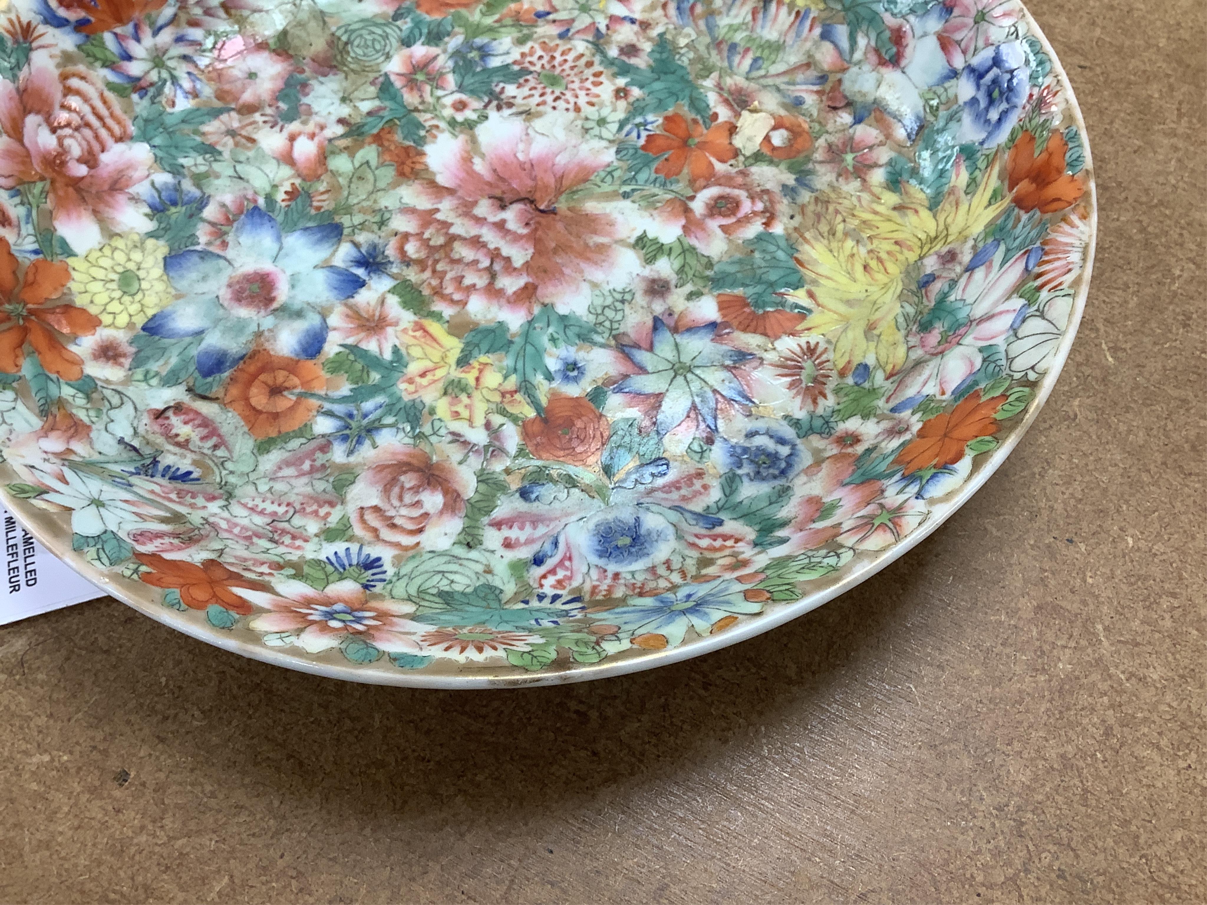 A Chinese enamelled porcelain millefleur dish, Qianlong mark, early 20th century, 24cm diameter. Condition - good